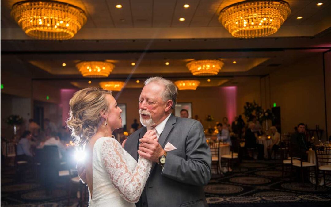 A father and daughter dancing at her wedding celebration.